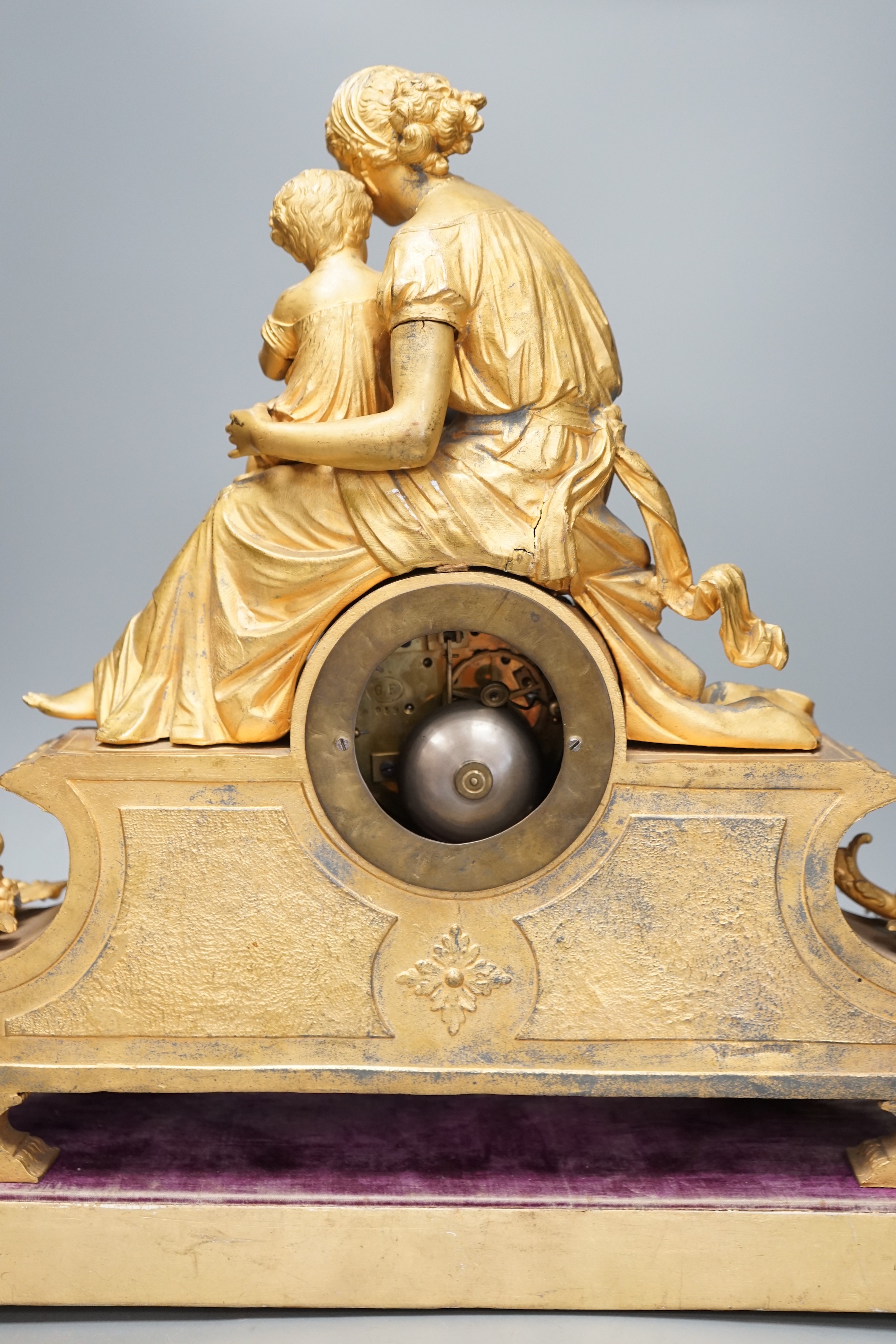 A 19th century 'Mother and child' French ormolu clock on plinth base, 44cm high